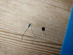 Resistor and DS18B20 Sensor Resistor and DS18B20 sensor on a wooden table.