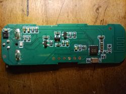 Green PCB with electronic SMD components on wooden surface