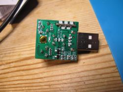 Green circuit board with a USB module and electronic components.