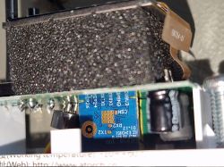 Close-up view of the interior of a DIN Rail Energy Monitor with exposed PCB module and protective foam.