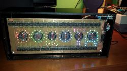 Nixie Clock with Personalized Backlighting Nixie tube clock in a plexiglass case with LED backlighting.