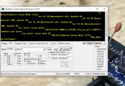 RealTerm software displaying serial port data with an electronic circuit board in the background.