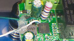 Close-up of a circuit board with electronic components and wires.