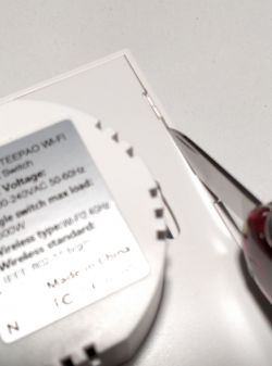 Opening TEEPAO WI-FI Switch Image showing the opening of a TEEPAO WI-FI curtain switch using a knife.