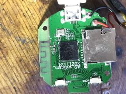 Close-up of a circuit board with electronic components, micro USB connector, and microSD slot.