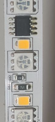 LED Strip with Integrated Circuit Close-up of an LED strip with several diodes and a small integrated circuit.