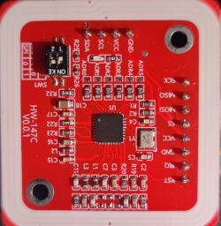 Red printed circuit board with various electronic components, including resistors and an integrated circuit.