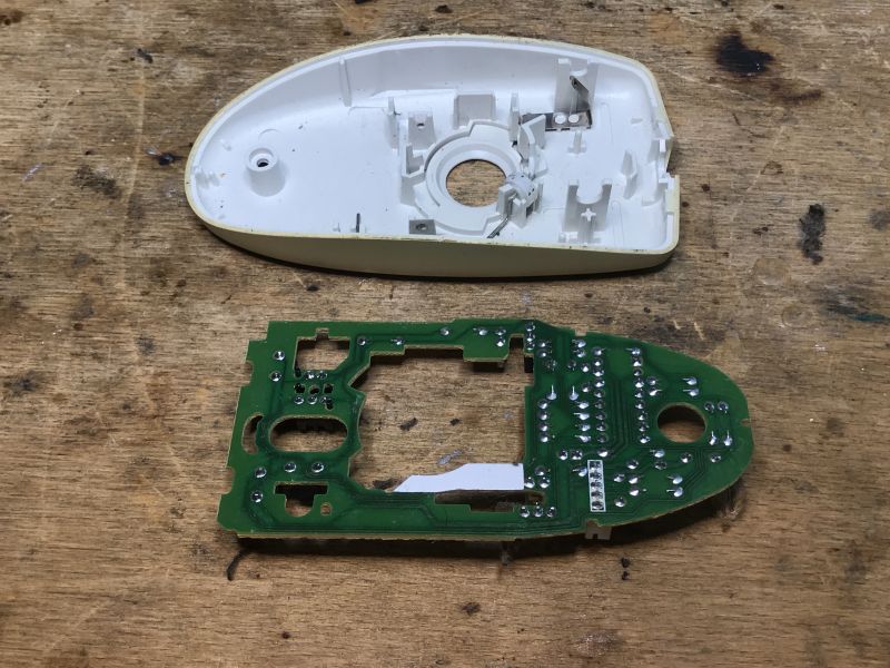 Interior of an Old Computer Mouse Interior of a disassembled computer mouse on a wooden surface