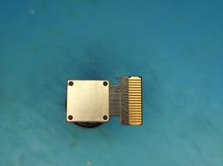 Camera module with flat ribbon connector on blue background
