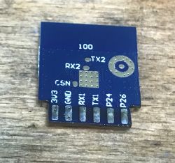PCB Module with Pin Labels PCB module with pin labels on a wooden surface.