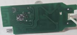 Printed Circuit Board with Green Laminate Printed circuit board with green laminate and conductive traces.