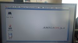 AmigaOS 3.2 startup screen with icons for Ram Disk, System, and Work.