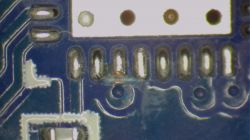 Close-up of electronic components on a blue printed circuit board.