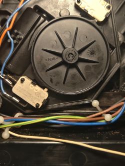 Zbliżenie na mechanizm koła zębatego Ekspresu Nivona 506 z widocznymi przewodami i przełącznikami.
