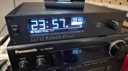 Homemade ESP32 music server displaying time and radio station.