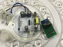 Close-up of a circuit board with electronic components on an LED panel.