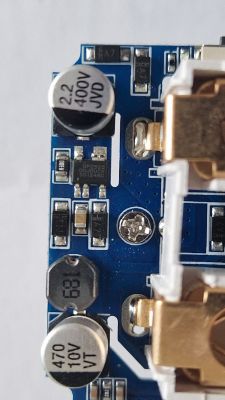 Interior of Smart Plug with Electronic Details Close-up of the interior of a smart plug showing electronic components such as capacitors and transistors.