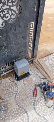 Automatic gate mechanism with tools on the floor.