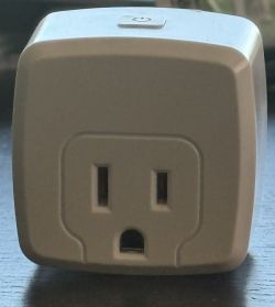 Smart Electrical Plug Image of a smart electrical plug with a button on top.