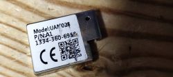 Metal label with model UAM028 marking, P/N: A1 code, and number 1334-360-6918. A QR code and CE symbol are also visible.