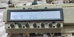 Washing machine LCD control panel with temperature and time Washing machine control panel with LCD showing 40°C and 0:50 timer