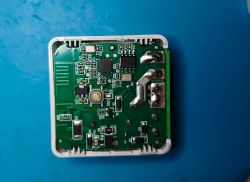 Circuit board with various electronic components on a blue background.