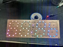 Panel with WS2812 LEDs arranged in a seven-segment display shape on a PCB.