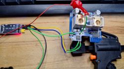 Electronic circuit board with colored wires connected to a USB to TTL adapter.
