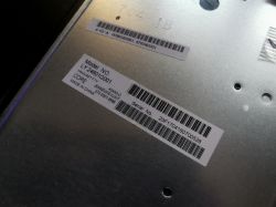 The image shows labels on a TV's metal plate, suggesting a model mismatch.