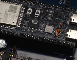 Close-up of ESP32S3 board with jumper marked between USB-C ports