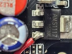 Close-up of AMS1117 voltage regulator and electrolytic capacitors on PCB