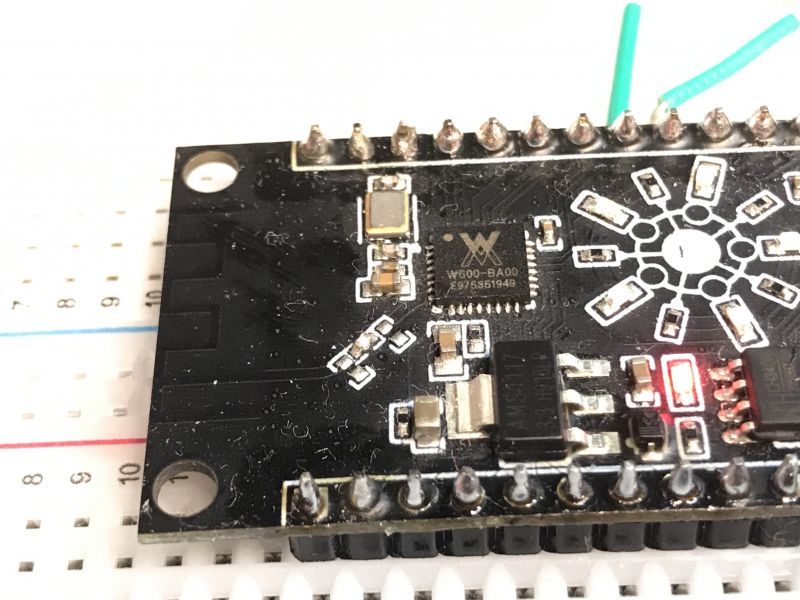 Close-up of a PCB with a W600-BA00 chip and an LED diode.