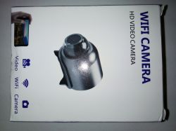 Small black car camera mounted on a windshield with a bracket.