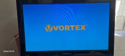 Television screen displaying VORTEX logo on a blue background.
