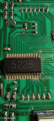 Close-up of a green circuit board with an IC labeled 5228