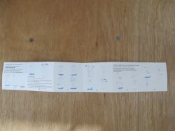 Device setup instructions on a wooden table.