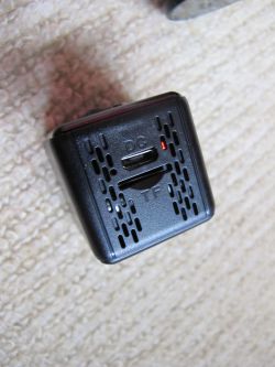 Bottom of Mini Spy Camera with Micro USB and TF Slot Close-up of the bottom of a mini spy camera with a micro USB port labeled DC, a TF microSD slot, and a red LED indicator.