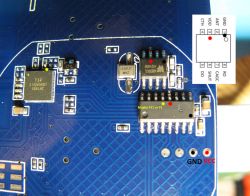 Close-up of a PCB with several integrated circuits and a pinout diagram.