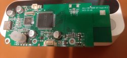 Circuit board with electronic components of a TUYA blood pressure monitor.