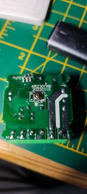 Close-up of a circuit board of a mini switch with markings and connectors.