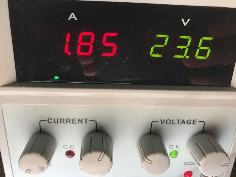 Power supply display showing 1.85 A and 23.6 V with control knobs