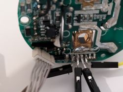 Flashing a Wall Socket Circuit Close-up of a wall socket's internal circuit with soldered wires.