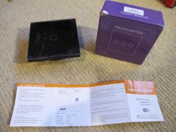Touch Switch with Instruction and Packaging Rectangular black touch switch next to a purple box and instruction manual.