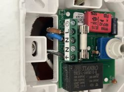 Interior of thermostat with wire terminals visible, black wire not yet connected