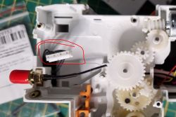 Interior of Tuya Device with Visible Gears Interior of the device with visible gears and a cable with a plug.