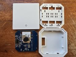 Disassembled wall module with AXYU Wi-Fi chip on a table.