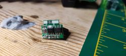 Close-up of a green circuit board with electronic components.