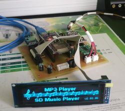 Close-up of MP3 player prototype with OLED display mounted on a PCB board
