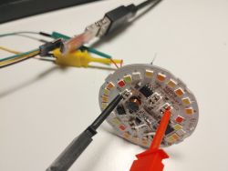 RGBW LED board with probes and wires connected to UART interface