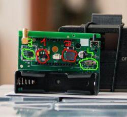 PCB with highlighted electronic components.